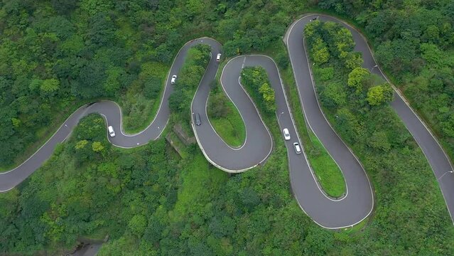 TAIWAN, TAROKO - MAY, 2023: Winding Road with Transport Traffic among Green Lush Forest Trees in Taroko Gorge National Park in Taiwan. Aerial Top View