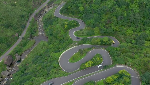 TAIWAN, TAROKO - MAY, 2023: Winding Road with Transport Traffic among Green Lush Forest Trees in Taroko Gorge National Park in Taiwan. Aerial Top View