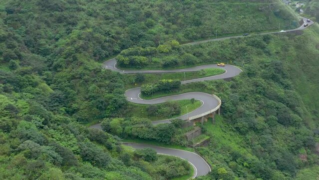 TAIWAN, TAROKO - MAY, 2023: Winding Road with Transport Traffic among Green Lush Forest Trees in Taroko Gorge National Park in Taiwan. Aerial Top View