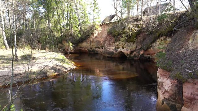 Sunny and calm afternoon by the shore of river with view on Sandstone outcrop