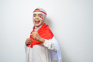Portrait of Young Asian Muslim Women celebrate Indonesian independence day holding red and white flag