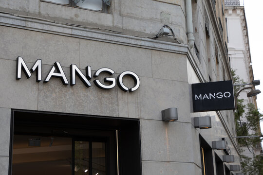 mango logo brand and text sign on wall facade shop entrance in city