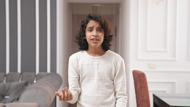 Frustrated Indian kid asking questions to someone
