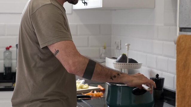 middle-aged caucasian man preparing food. Cook in the kitchen at home
