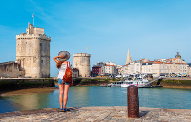 Woman tourist visiting La Rochelle- Tour tourism in France, Charente Maritime - obrazy, fototapety, plakaty