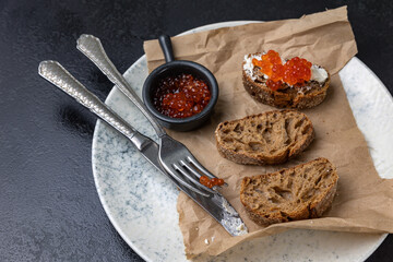 A plate of toasts with red caviar