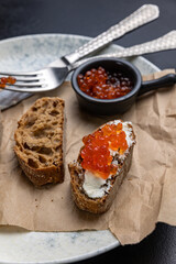 A plate of toasts with red caviar