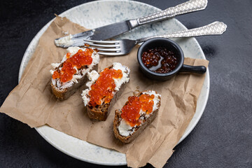 A plate of toasts with red caviar