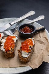 A plate of toasts with red caviar