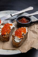 A plate of toasts with red caviar