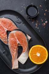 salmon fillets on a black plate 