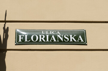 Floriańska street name sign in the Old Town district of Krakow, Poland. Information plate on a building wall in Kraków. St. Florian's Florianska, famous promenade, one of the main streets of Cracow. - obrazy, fototapety, plakaty