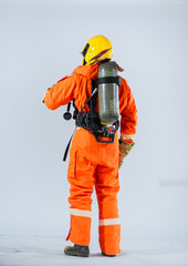 Fototapeta premium With the oxygen tank positioned on his back the firefighter highlighting his commitment to ensuring personal safety while carrying out life saving duties.