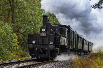 Fototapeta na wymiar a ride on a historic steam tourist train pulled by a Czech locomotive