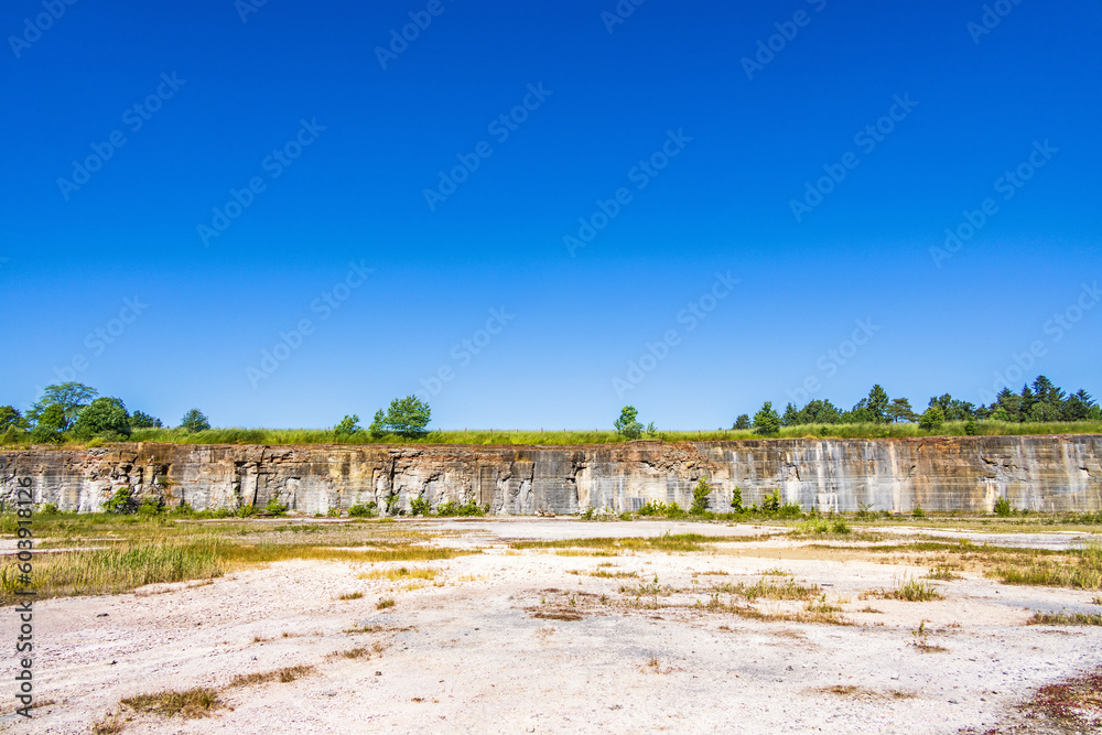 Poster Old abandoned quarry with a rock face