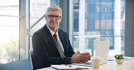 Mature businessman, portrait and in an office with a laptop for communication and connectivity. Corporate, company and a manager or boss of an agency with a pc for networking and internet at work
