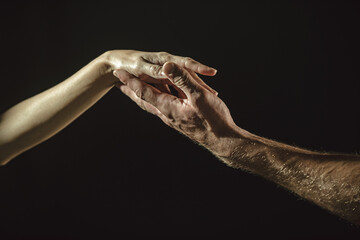 Fototapeta na wymiar Touch of two hands. Man and woman hand about to touch with index finger. Couple in love reaching to each other. Hand try to touch. Couple hands reaching towards each other. Couple hand touch.