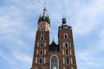 Fototapeta na wymiar St. Mary's Basilica at the Main Market Square in the Old Town district of Krakow, Poland. Bazylika Mariacka Kraków, Kościół Mariacki church in Cracow.