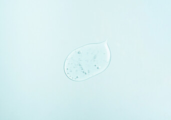 Cosmetic samples texture with bubbles. Smears of transparent liquid cosmetics on a blue background