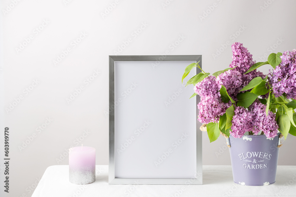 Wall mural Floral card or poster mockup or silver photo frame in modern style with lilac plant flowers in bucket vase on white table cloth.