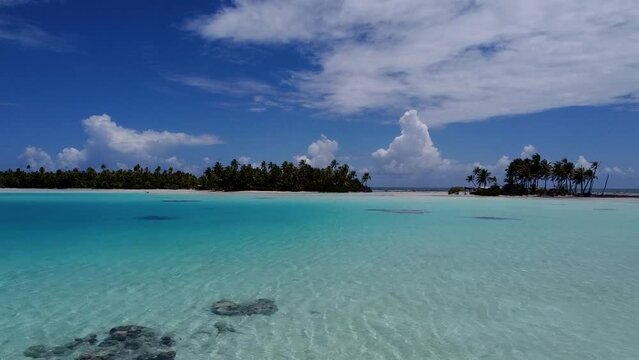 Aerial video of blue water surrounding a tropical island in French Polynesia 