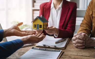 home loan officer sending house model to client after signing agreement contract real estate with approved mortgage application form, concerning mortgage loan offer for and house insurance.