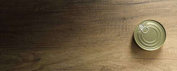 Blank canned food jar on wooden background