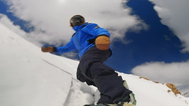 GoPro snowboard mount camera on board male snowboarder fast down mountain turning slashing powder unique perspective epic ikon pass Colorado out of bounds ski resort cloudy sunny powder adventure day