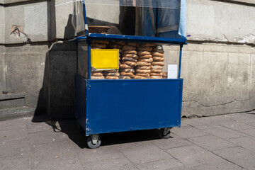Street vendor cart selling Krakowskie Obwarzanki in Krakow, Poland. Kraków Booth stall with...