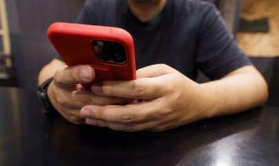 Man playing game on mobile phone. gamer boy playing video games holding Smartphone working mobile devices. cell telephone technology e-commerce concept.