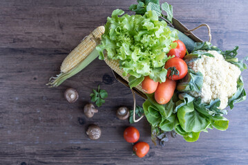 Shopping or delivery healthy food background. a fresh group of vegetables on wood background. burlap bag filled with vegetables and fruits , healthy eating and organic agriculture concept.