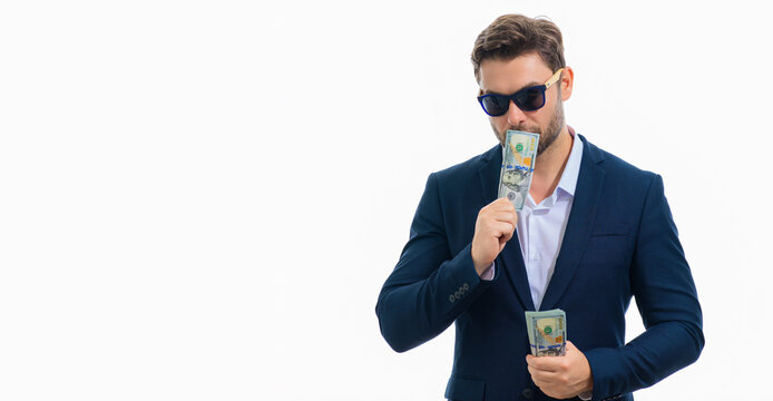 Business man hold money on white studio isolated background. Rich man in suit with money dollar bills. Successful businessman with dollar banknotes. Rich millionaire in suit holding money, banner.