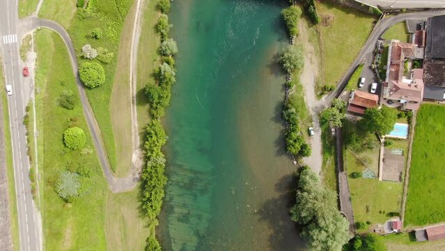 Aerial view of a drone above the gave the oloron revealing with the camera beautiful colors with the deck qur of mousserolles next to the city of Navarrenx, France