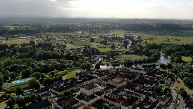 Aerial timelapse of a French village near the mountains and a river