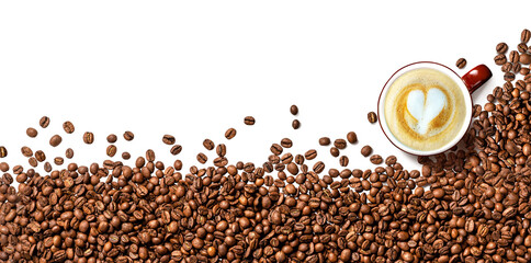 Coffee beans on white background. Top view of coffee beans with a cup of cappuccino coffee. Copy...