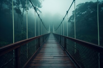 Obraz premium Suspension bridge in the jungle at foggy weather. Beautiful illustration picture. Generative AI
