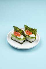 Portion of japanese hand rolls with caviar and avocado