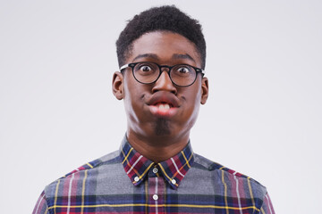 Funny face, comic and portrait of a black man being crazy isolated on a white background in a studio. Geek, mouth movement and face headshot of an African person with glasses as a nerd and goofy