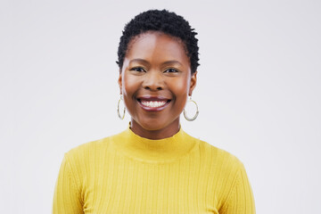 Happy, smile and portrait of a black woman with a headshot isolated on a white background in a studio. Happiness, business and face of a young African employee smiling for a corporate profile