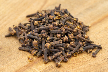 Clove. Dried Clove on wooden background. Spice concept. Close up