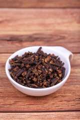 Clove. Dried Clove on wooden background. Spice concept