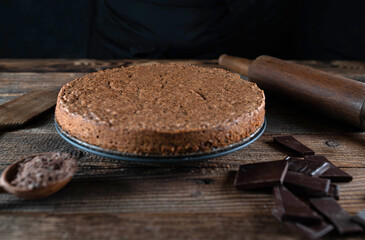 Fresh baked torta caprese. Italian chocolate, almond cake on rustic and wooden table.