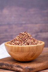 Sumac seeds. Dried sumac berries on wooden background. Spice concept