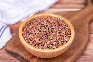 Sumac seeds. Dried sumac berries on wooden background. Spice concept. Close up