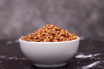 Sumac seeds. Dried sumac berries on dark background. Spice concept