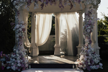 Beautiful wedding set up. Area of the wedding ceremony with round arch, decorated with flowers. Festive decor at nature.