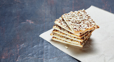 Crisp bread with seeds. Crunchy crispbread on a wooden background. Healthy snack: cereal crunchy multigrain cereal flax seed, sunflower seeds protein bread bar