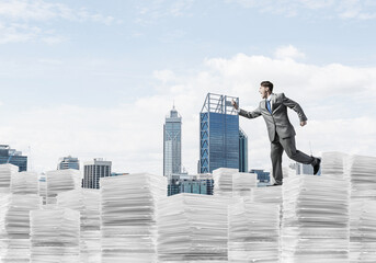 Precise businessman in suit running with phone.