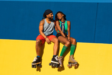 Cheerful couple with roller skating outside. Fun sexy boyfriend and girlfriend enjoy outside.