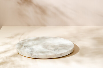 Marble showcase with plant leaves shadows on beige and brown background, minimal background for product presentation